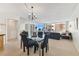 Open-concept dining area with glass table, carpeted floors, and expansive windows with a view at 17920 Gulf Blvd # 1302, Redington Shores, FL 33708