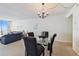 Open-concept living space with glass table, carpeted floors, and expansive windows with water views at 17920 Gulf Blvd # 1302, Redington Shores, FL 33708