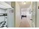 Hallway leading into an open concept living room and kitchen area with a view of the beach at 17920 Gulf Blvd # 1302, Redington Shores, FL 33708