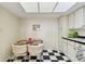Cozy kitchen featuring black-and-white tile flooring and a dining area with seating for four at 17920 Gulf Blvd # 1302, Redington Shores, FL 33708