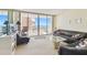 Relax in this living room with an ocean view from the balcony that offers comfortable seating at 17920 Gulf Blvd # 1302, Redington Shores, FL 33708