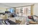 A bright living room with sliding glass doors to a balcony, featuring ample seating and ocean views at 17920 Gulf Blvd # 1302, Redington Shores, FL 33708
