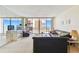 The living room offers ocean views from the balcony with comfortable seating and a mirrored wall at 17920 Gulf Blvd # 1302, Redington Shores, FL 33708