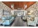 A welcoming lobby with beautiful stone walls, comfortable couches, tiled floors and beach decor at 17920 Gulf Blvd # 1302, Redington Shores, FL 33708