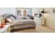 Bedroom featuring a bed, dresser with television, view of a balcony with patio furniture, and exterior view at 17920 Gulf Blvd # 1302, Redington Shores, FL 33708
