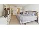 Bedroom featuring a queen bed, dresser with television, and doorway access to a bathroom and closet at 17920 Gulf Blvd # 1302, Redington Shores, FL 33708