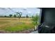 View of backyard showcasing well-maintained lawn and landscaping at 1853 Hovenweep Rd, Wesley Chapel, FL 33543