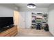 This bedroom has a contemporary light fixture and a display shelf for collectibles at 1853 Hovenweep Rd, Wesley Chapel, FL 33543