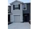 Charming two-story townhouse with a gray exterior and well-maintained front yard at 1853 Hovenweep Rd, Wesley Chapel, FL 33543