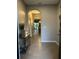 Inviting foyer showcasing a light-filled hallway with elegant archways leading to the living spaces at 1853 Hovenweep Rd, Wesley Chapel, FL 33543