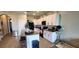 Bright kitchen with white cabinetry, modern appliances, and a spacious center island with bar stools at 1853 Hovenweep Rd, Wesley Chapel, FL 33543