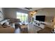 Comfortable living room with a plush sofa, stylish decor, and access to an outdoor patio at 1853 Hovenweep Rd, Wesley Chapel, FL 33543