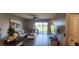 Bright living room with a sectional sofa, modern furnishings, and an open floor plan at 1853 Hovenweep Rd, Wesley Chapel, FL 33543