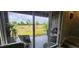 Sliding glass door view of outdoor patio, grill, and backyard at 1853 Hovenweep Rd, Wesley Chapel, FL 33543