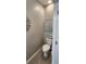 Contemporary powder room featuring a toilet, tiled flooring, and modern wall art at 1853 Hovenweep Rd, Wesley Chapel, FL 33543
