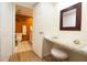 Bathroom featuring a dressing table with a stool, along with a toilet and sink at 2101 Sunset Point Rd # 1806, Clearwater, FL 33765