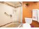 Bathroom featuring a glass walk-in shower and toilet with decorative wall art at 2101 Sunset Point Rd # 1806, Clearwater, FL 33765