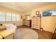 Bright bedroom with a TV, wood floors, plantation shutters, and decorative dresser at 2101 Sunset Point Rd # 1806, Clearwater, FL 33765