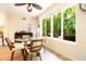 Bright breakfast nook featuring a glass table and a large window with a lush, tropical backyard view at 2101 Sunset Point Rd # 1806, Clearwater, FL 33765