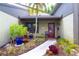 Inviting front entrance with colorful landscaping, featuring a charming doorway and walkway, creating a warm welcome at 2101 Sunset Point Rd # 1806, Clearwater, FL 33765