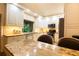 Modern kitchen with white cabinetry, granite countertops, and stainless steel appliances, designed for culinary enthusiasts at 2101 Sunset Point Rd # 1806, Clearwater, FL 33765