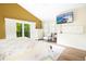 Spacious main bedroom with balcony access, featuring a TV, vaulted ceiling, and a neutral color palette at 2101 Sunset Point Rd # 1806, Clearwater, FL 33765