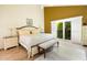 Inviting main bedroom with a king bed, slider to a balcony, and sunny natural light at 2101 Sunset Point Rd # 1806, Clearwater, FL 33765
