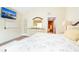 Comfortable main bedroom features a TV, en suite bathroom, and a bright, welcoming ambiance at 2101 Sunset Point Rd # 1806, Clearwater, FL 33765