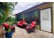 Cozy outdoor patio area with wicker furniture and lush greenery, perfect for relaxing at 2101 Sunset Point Rd # 1806, Clearwater, FL 33765