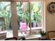 Breakfast nook view of a private patio with lush tropical foliage, offering a serene outdoor escape at 2101 Sunset Point Rd # 1806, Clearwater, FL 33765