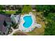 Aerial view of the community pool with lounge chairs and tables for relaxation and outdoor enjoyment at 2101 Sunset Point Rd # 1806, Clearwater, FL 33765