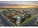 Community aerial view showcasing clubhouse, pool, playground, and meticulously landscaped grounds at sunset at 2529 Arbor Wind Dr, Lutz, FL 33558