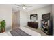 Bedroom with TV, comfortable decor, ceiling fan, and stylish artwork at 2529 Arbor Wind Dr, Lutz, FL 33558
