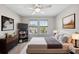 Bedroom with a large bed, lots of sunlight, and stylish decorations at 2529 Arbor Wind Dr, Lutz, FL 33558
