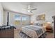 Bright bedroom featuring a comfortable bed, large windows, and stylish decor at 2529 Arbor Wind Dr, Lutz, FL 33558