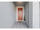 Neutral colored home featuring a solid wood front door and gray brick paver entrance at 2529 Arbor Wind Dr, Lutz, FL 33558