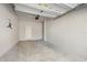 View of a clean, spacious two car garage with neutral color walls, concrete floor, and overhead door at 2529 Arbor Wind Dr, Lutz, FL 33558