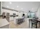 Open concept kitchen featuring a center island with seating, stainless steel appliances, and wood look tile flooring at 2529 Arbor Wind Dr, Lutz, FL 33558