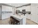 Bright kitchen with white cabinets, stainless steel appliances, center island with seating, and decorative backsplash at 2529 Arbor Wind Dr, Lutz, FL 33558