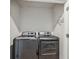 Laundry room with modern front load washer and dryer at 2529 Arbor Wind Dr, Lutz, FL 33558