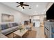 Inviting living room with a comfortable sofa, a view of the kitchen, and wood look tile flooring at 2529 Arbor Wind Dr, Lutz, FL 33558