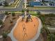 Aerial view of community playground area with swings, slides, and soft ground covering ensures safety and fun at 2529 Arbor Wind Dr, Lutz, FL 33558