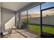 Relaxing screened patio featuring tiled floors, offering seamless indoor-outdoor living with serene backyard views at 2529 Arbor Wind Dr, Lutz, FL 33558