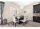 Well-lit dining room with plantation shutters, stylish lighting, and a modern dining set at 2608 Calvano Dr, Land O Lakes, FL 34639