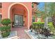 Charming front entrance with double doors, decorative plants, and a 'welcome' sign at 2608 Calvano Dr, Land O Lakes, FL 34639