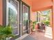 Inviting front porch with double glass doors, a 'welcome' sign, and comfortable seating area at 2608 Calvano Dr, Land O Lakes, FL 34639