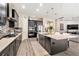 Spacious kitchen with black cabinets, stainless steel appliances, a large island, and eat in kitchen at 2608 Calvano Dr, Land O Lakes, FL 34639