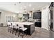 Bright kitchen featuring a large island with bar seating, pendant lighting, and stainless steel appliances at 2608 Calvano Dr, Land O Lakes, FL 34639