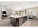 Open kitchen with center island and a view to dining and living rooms at 2608 Calvano Dr, Land O Lakes, FL 34639
