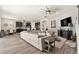 Open-concept living area featuring hardwood floors, modern decor and a view to kitchen at 2608 Calvano Dr, Land O Lakes, FL 34639